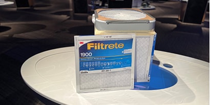 An assembled Corsi Rosenthal Box next to a Filtrete Air Filter