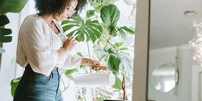 a woman watering house plants