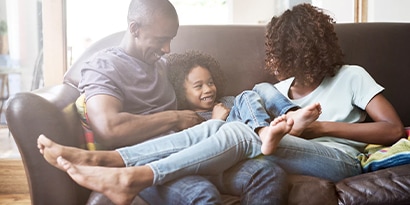 A family cuddling on the couch together