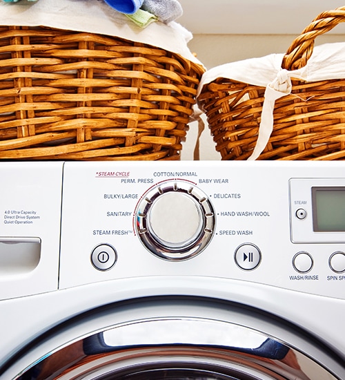 Laundry baskets on washing machine.