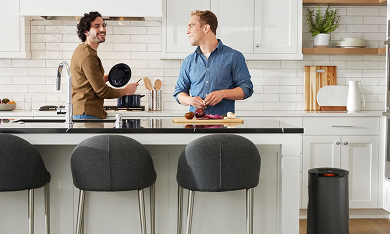 Two men cooking in kitchen with large Filtrete™ Smart Air Purifier
