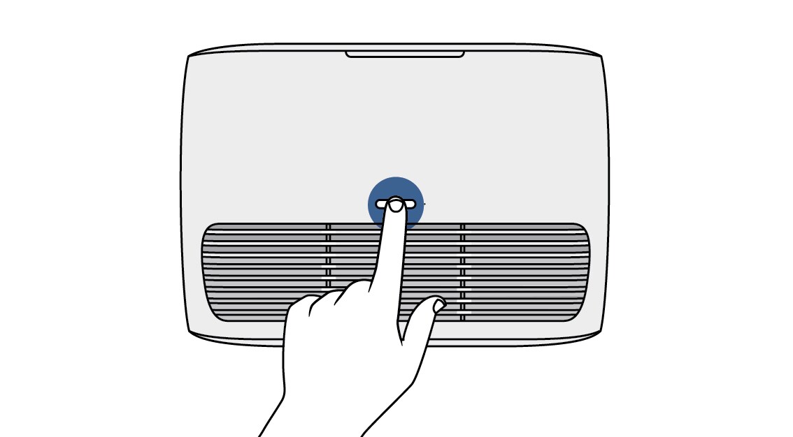 Finger holding down the reset button on the top of Filtrete™ air purifier tabletop device
