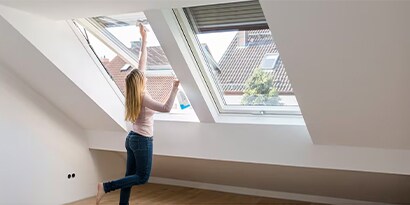 In six simple moves, you can turn your cleaning routine into a workout. Woman washing a window.
