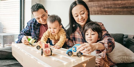 Family playing with toy cars