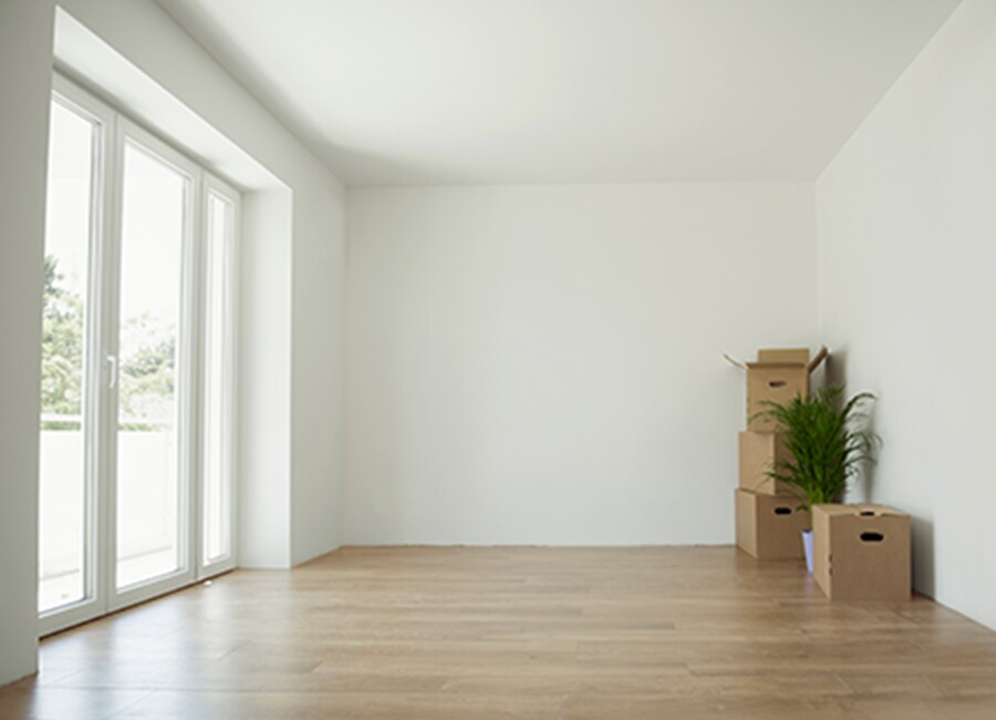 Empty Room with Wood Floors and Moving Boxes
