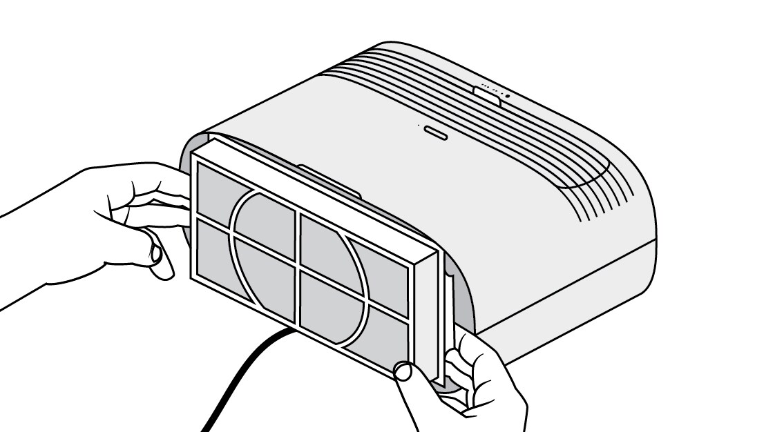 Removing used air filter from Filtrete™ air purifier tabletop device using two hands
