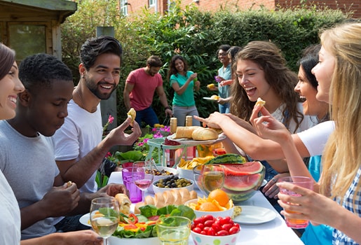 Better understand how the air around you is changing with these insights from two new reports. A family relaxing eating a meal together in a backyard.