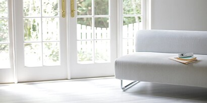 The interior of a home looking out two french doors.
