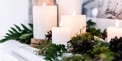 Lit candles on a shelf