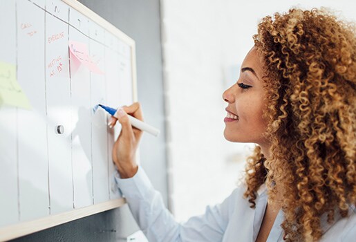 Woman writing on a wall calendar