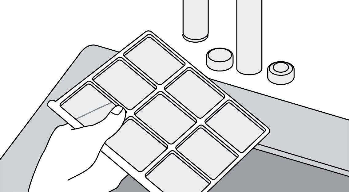 Air filter screens being rinsed in a sink
