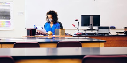 Teacher in a classroom reading