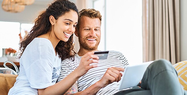 Couple making an online purchase on a tablet
