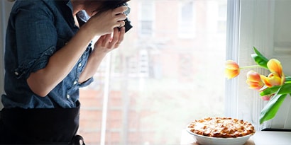 person taking photo of pie