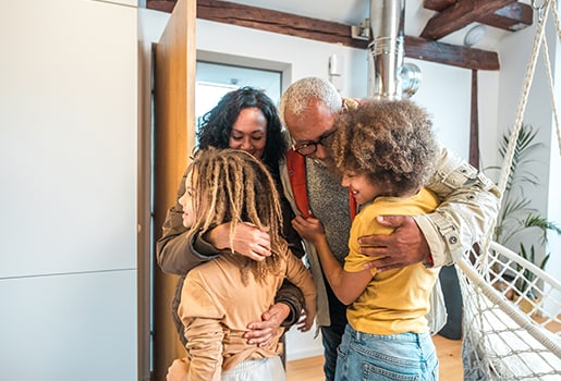 A family having a group hug together. Eight tips to help improve your indoor air quality quickly.