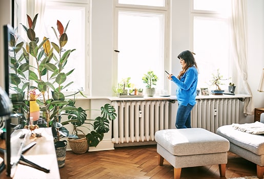 Woman standing near radiator
