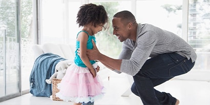 a man holding a child, both smiling