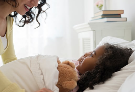 If allergies are keeping you up, try these remedies to get more zzzs. Image of a mother waking up her daughter.