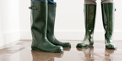 two people wearing rain boots, close up of the boots.