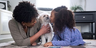 a woman and child with their dog