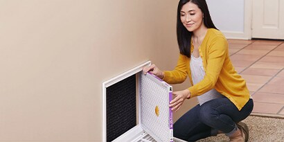 person replacing their air filter