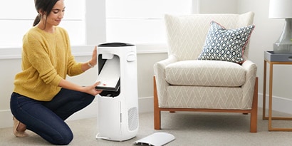 Woman cleaning an Air Purifier