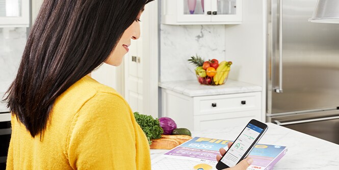 Woman using the Filtrete Smart App, checking her filter change reminders
