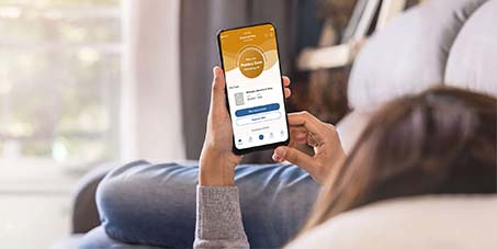 Woman on phone using Filtrete Smart App