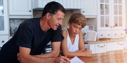 A father helping his kid with homework.
