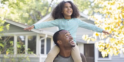 Man with happy child on his shoulders