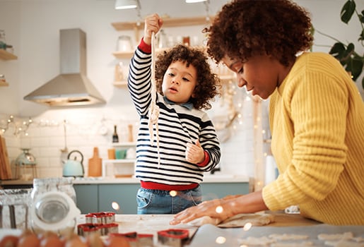 A mother and daughter baking in the kitchen together. Use these tips to help maintain good indoor air quality in the kitchen.