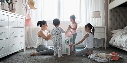 A family playing with a dollhouse together