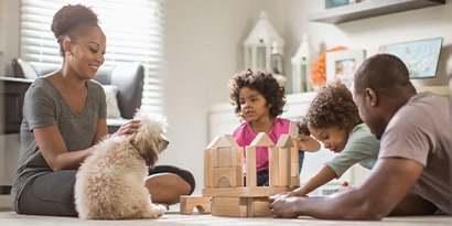 Family playing with kids and dog