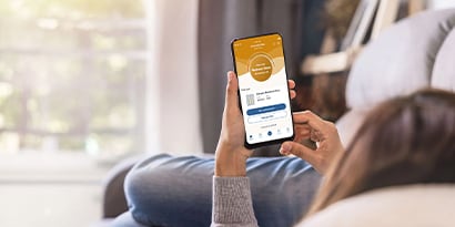 A woman using the Filtrete Smart App to check the Air Filter status