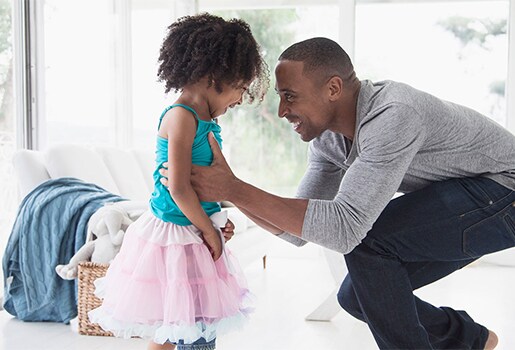 When did you last examine the strength of your air filter&rsquo;s Microparticle Performance Rating? A Father holding his daughter wearing a pink tutu in a brightly lit windowed room.